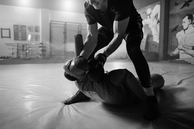 a black and white photo of two people in a gym, figuration libre, fighting aggression, submission, instagram post, people fighting