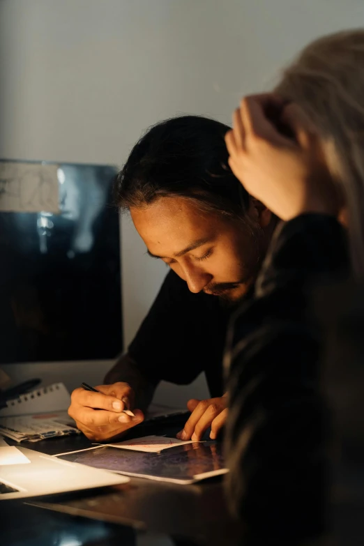 a couple of people that are sitting at a table, a drawing, pexels contest winner, process art, greg rutkowski and ross tran, writing on a clipboard, dark light, yohji yamamoto