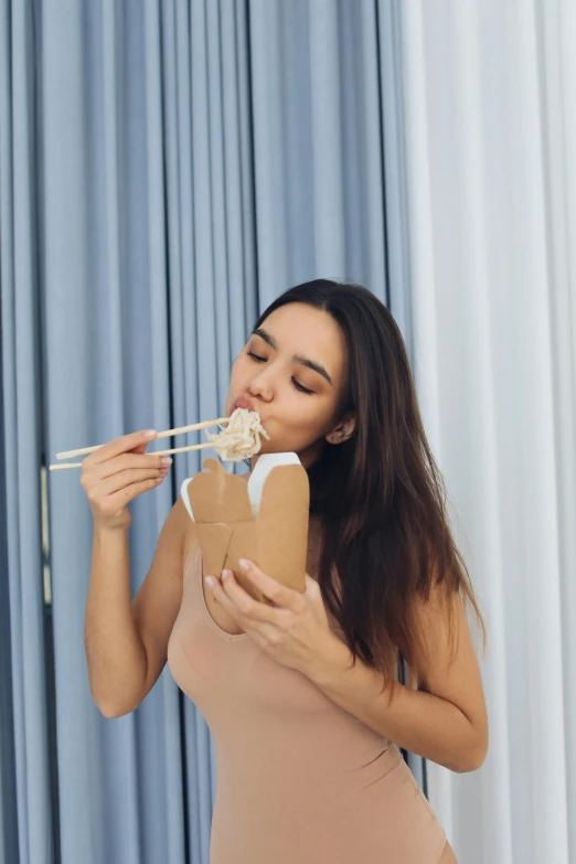 a woman eating sushi with chopsticks in her mouth, inspired by Tan Ting-pho, unsplash, conceptual art, candid photo of gal gadot, made of lab tissue, wearing a camisole, gif