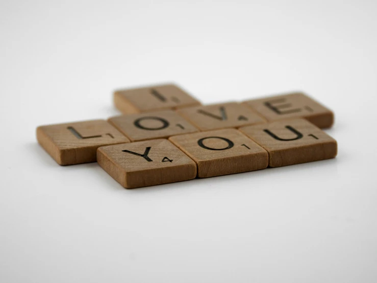wooden scrabbles spelling i love you on a white background, by Sylvia Wishart, unsplash, letterism, 1 7 9 5, bespoke, tan, wallpaper - 1 0 2 4
