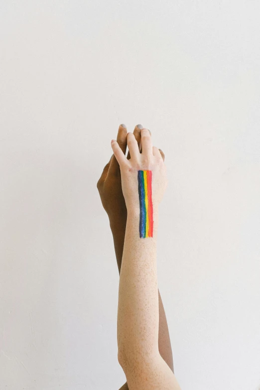 a person with a rainbow tattoo on their arm, trending on pexels, stripes, paul rand, temporary tattoo, ilustration