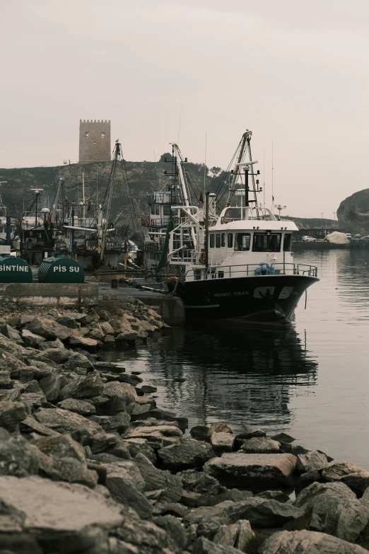 a boat that is sitting in the water, a picture, pexels contest winner, port scene background, scylla, mining, grey