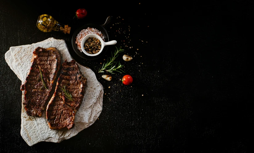 a piece of steak sitting on top of a piece of paper, background image, listing image, on a black background, cooking it up