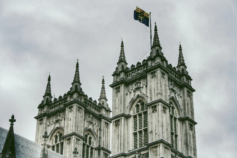 a very tall building with a flag on top of it, by Emma Andijewska, unsplash, baroque, underwater westminster, alabaster gothic cathedral, square, 1990s photograph
