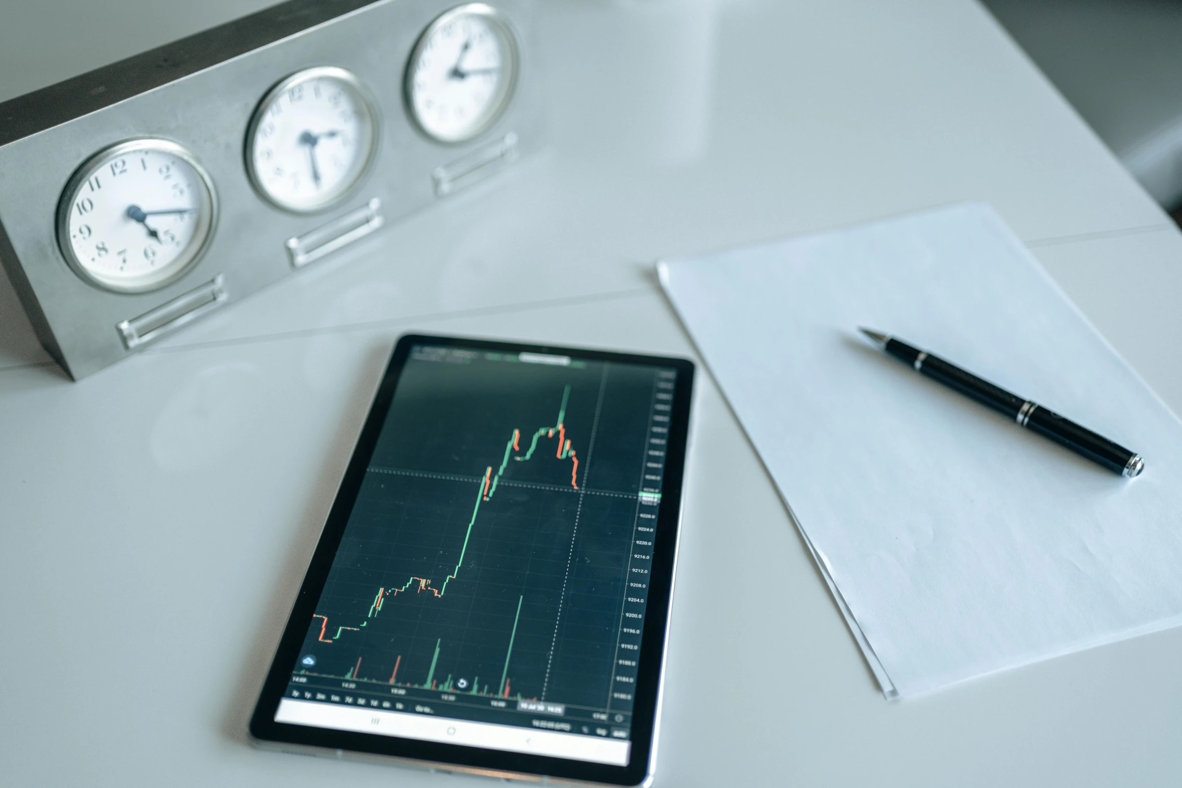 a tablet computer sitting on top of a white table, by Adam Marczyński, trending on pexels, analytical art, displaying stock charts, dials, square, 15081959 21121991 01012000 4k