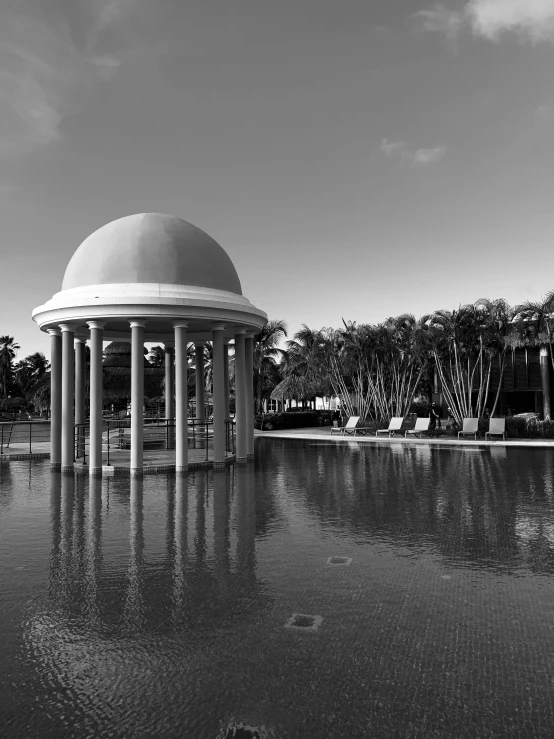 a black and white photo of a gazebo, inspired by Ricardo Bofill, next to a tropical pool, puerto rico, dome, in the 4 0 th millenia