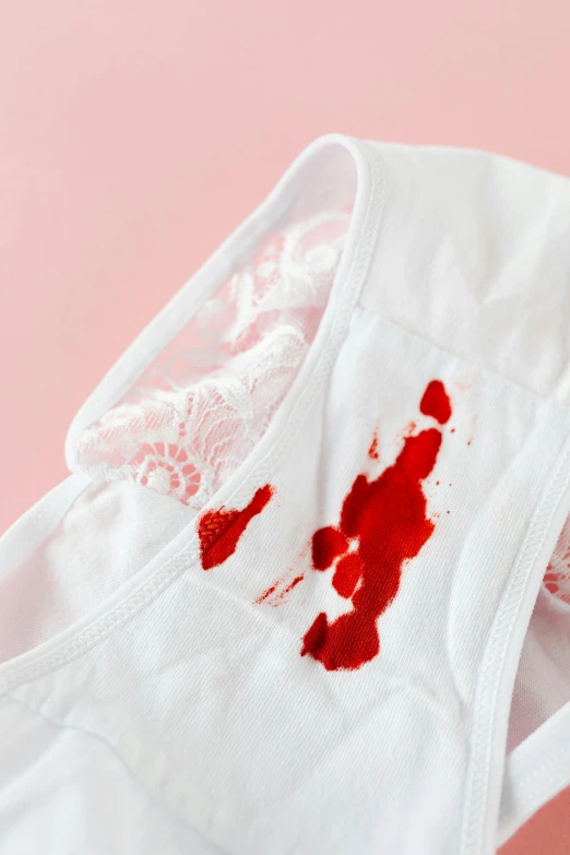 a pair of underwear with blood on it, by Julia Pishtar, up-close, white, full product shot, puking blood