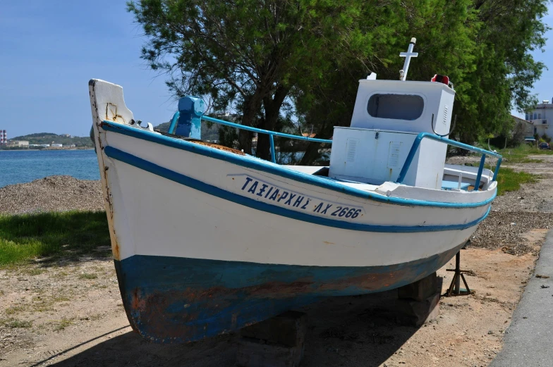 a white and blue boat sitting on the side of a road, tangelos, profile pic, preserved historical, thumbnail