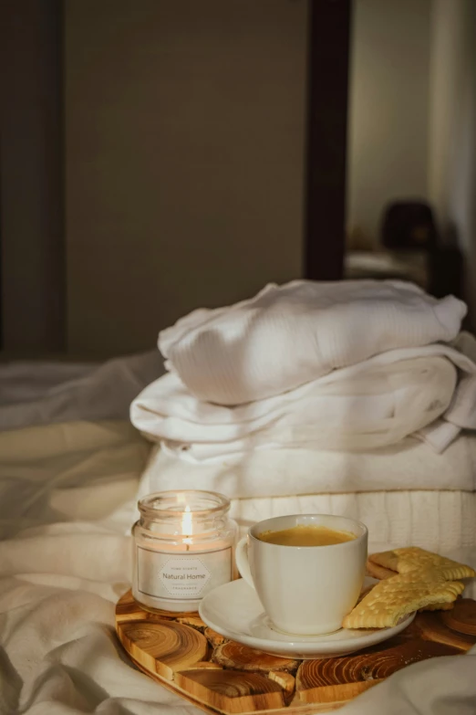 a tray with a cup of coffee on top of a bed, a portrait, inspired by Riad Beyrouti, trending on unsplash, candle wax, soft diffused light, spa, honey