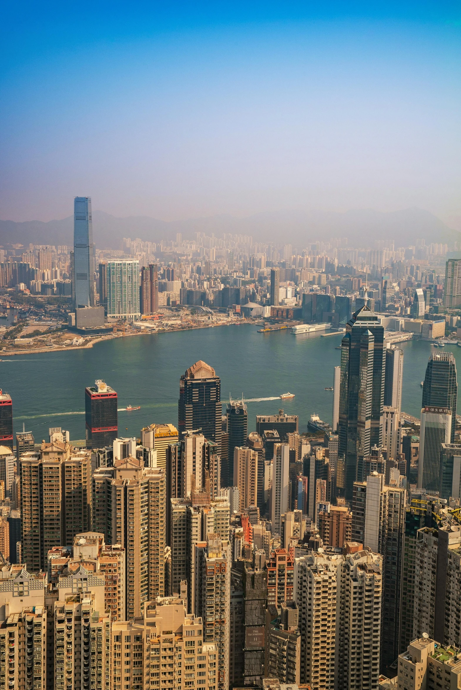 a view of a city from the top of a building, by Patrick Ching, pexels contest winner, happening, city like hong kong, sunny day time, slide show, very hazy