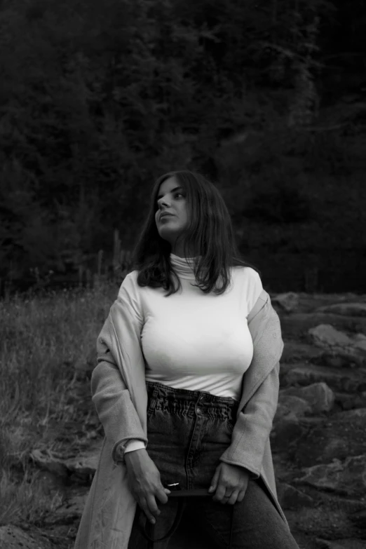 a black and white photo of a woman sitting on a rock, inspired by Hannah Frank, in white turtleneck shirt, thicc, charli bowater, wide torso