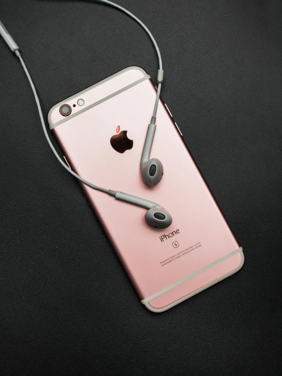 a pink iphone with earphones attached to it, by Dan Luvisi, trending on pexels, grey and silver, instagram picture, duo tone, ( ultra realistic