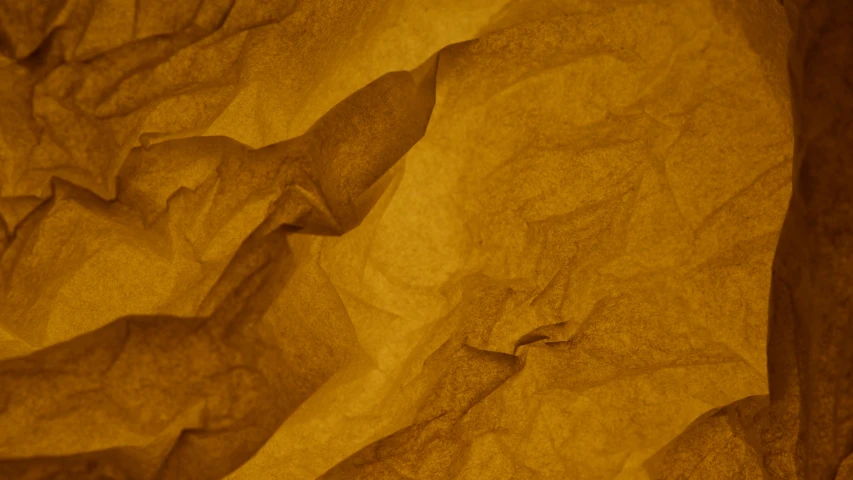 a close up of a piece of paper on a table, by Thomas Häfner, pexels contest winner, process art, golden fabric background, mountainous, 15081959 21121991 01012000 4k, brown paper