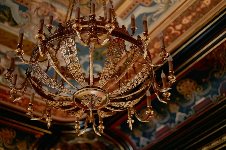 a chandelier hanging from the ceiling in a room, inspired by Luis Paret y Alcazar, pexels, baroque, made of intricate metal and wood, ornate gilded medieval icon, a medium shot, byzantine