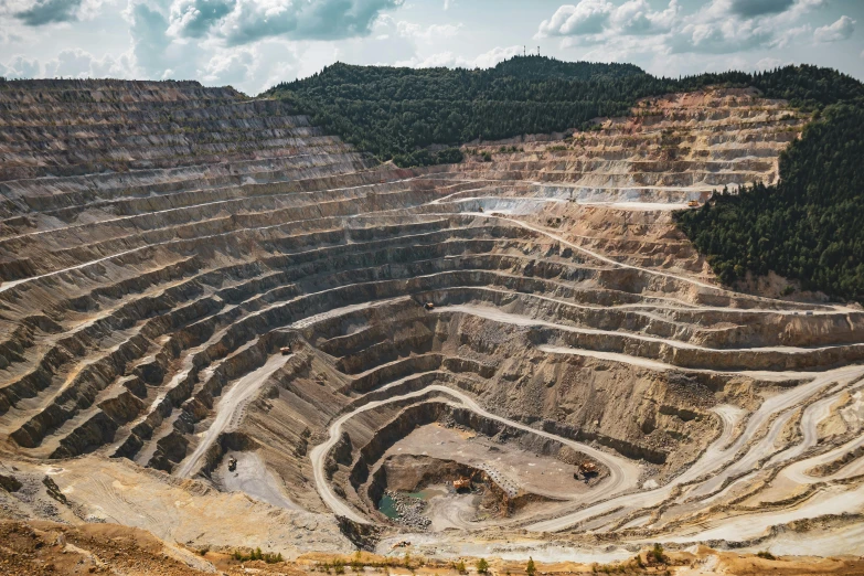 a large open pit filled with lots of dirt, unsplash contest winner, renaissance, titanium, slightly pixelated, gold, thumbnail