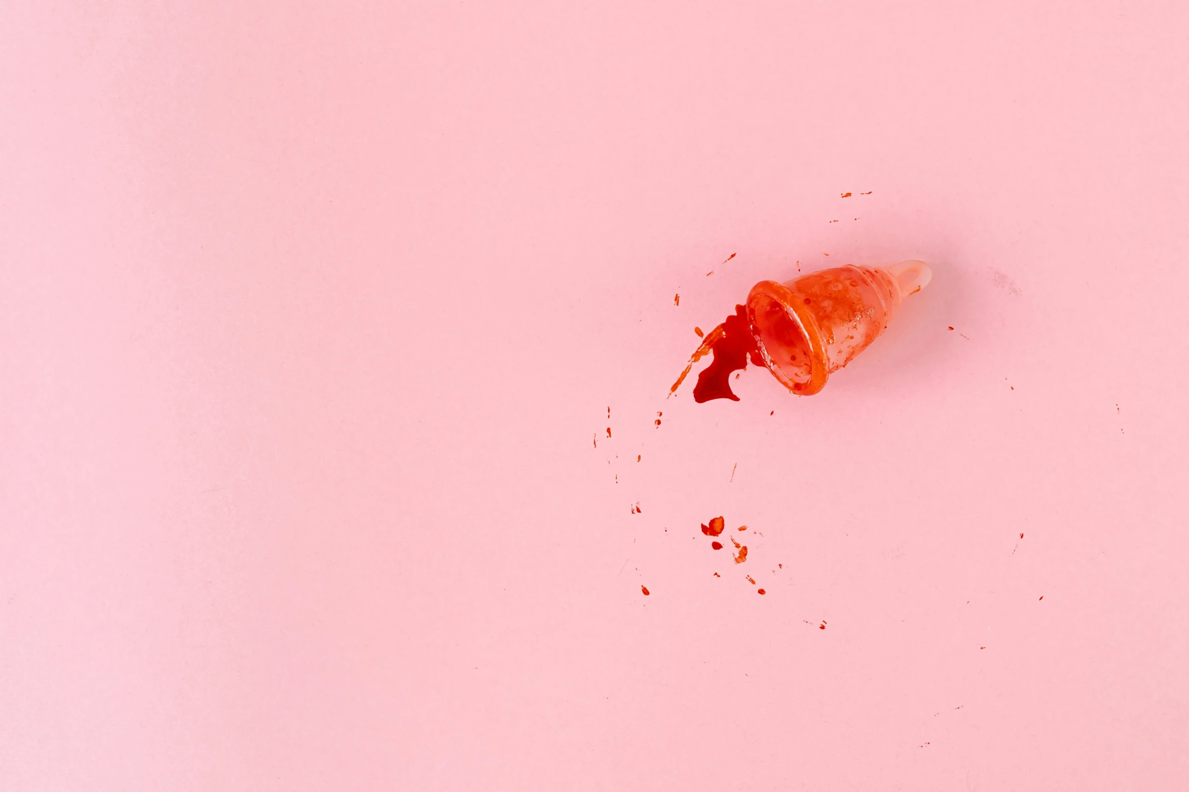 an ice cream cone sitting on top of a pink surface, by Sam Havadtoy, pexels, magic realism, blood drop, bloody scene, ignant, conch shell