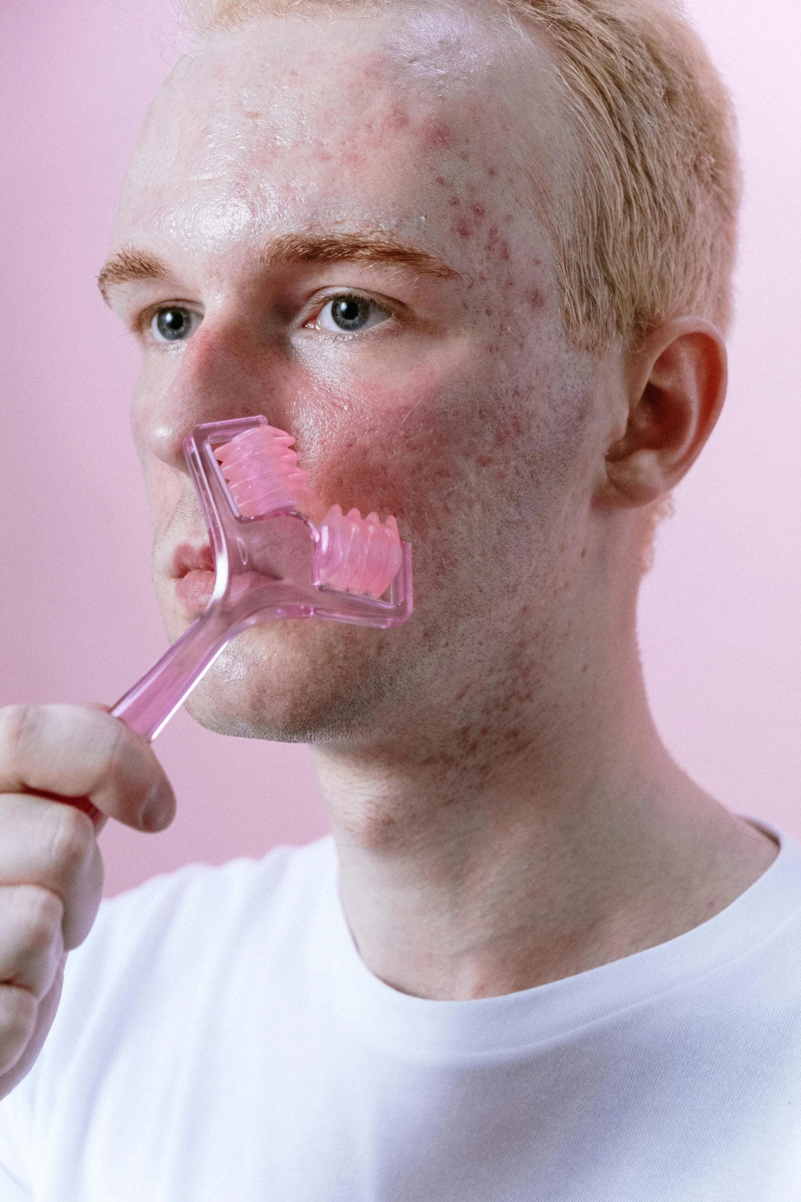 a man brushing his teeth with a pink toothbrush, by Adam Marczyński, reddit, renaissance, trypophobia acne face, translucent gills, square jaw, made of cotton candy