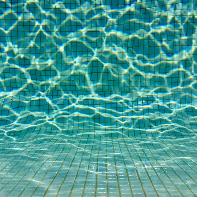 the bottom of a swimming pool with clear water, inspired by David Hockney, shutterstock, square lines, water on lens, demur, olafur eliasson