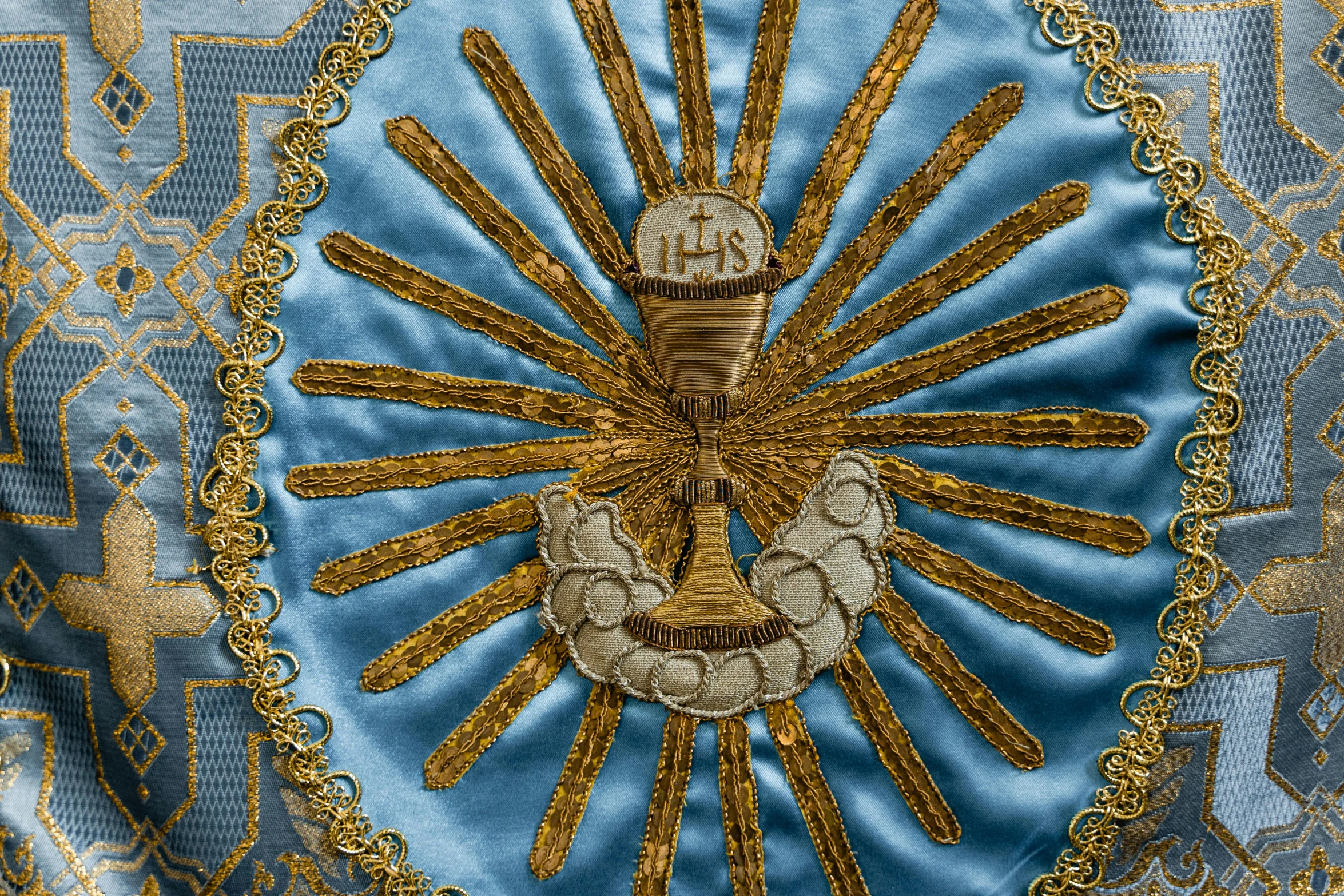 a blue and gold brocade with a crown on it, holding holy symbol, solis sacerdotibus, promo image, fan favorite