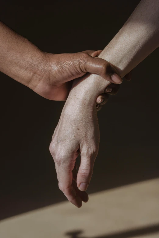 a close up of two hands holding each other, by Alison Geissler, tension, paul barson, conor walton, pose 4 of 1 6