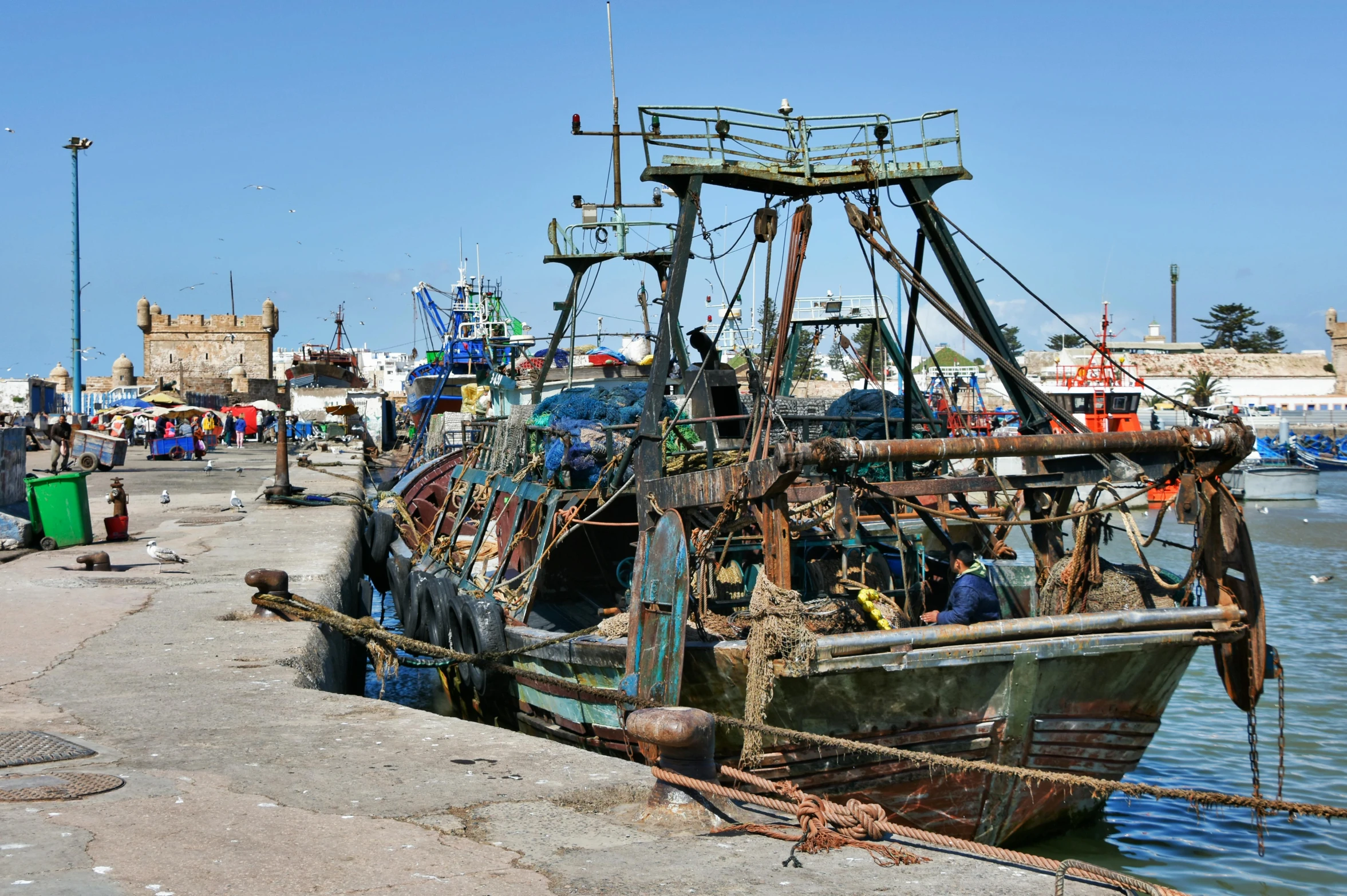 a boat that is sitting in the water, hurufiyya, fish seafood markets, square, brown, thumbnail