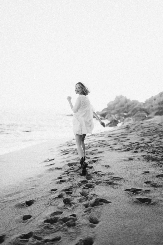 a black and white photo of a woman running on a beach, by Felix-Kelly, wearing a cute white dress, monia merlo, medium format, 15081959 21121991 01012000 4k