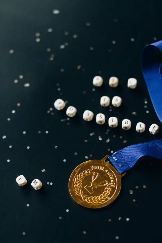 a gold medal sitting on top of a blue ribbon, by Julia Pishtar, pexels contest winner, cubes on table, taken from orbit, with silver runes on it, healthcare