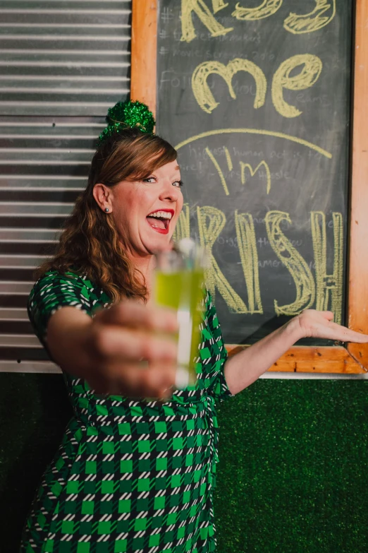 a woman in a green dress holding a drink, happening, irish genes, 1 0 / 1 0 comedy, profile image, show