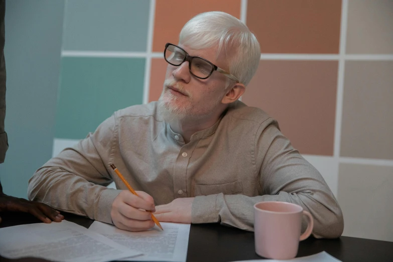 a man sitting at a table with a pencil in his hand, albino hair, 15081959 21121991 01012000 4k, high-quality photo, studying