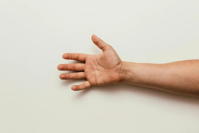 a close up of a person's hand on a wall, pexels, hyperrealism, set against a white background, marfan syndrome, plain background, dry skin