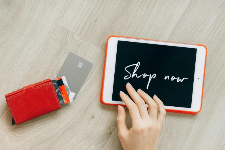 a person holding a tablet with the word shop now written on it, by Julia Pishtar, flatlay, banner, not cropped, holding ace card