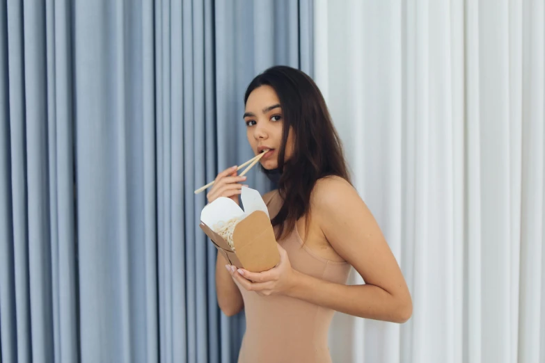 a woman in a tan bodysuit smokes a cigarette, inspired by Pia Fries, pexels contest winner, happening, holding a boba milky oolong tea, hailee steinfeld, avatar image, cardboard