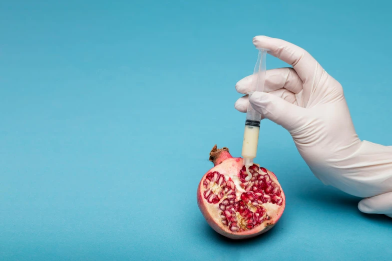 a person in a white glove is holding a pomegranate, surgical iv drip, getty images proshot, instagram post, dna experiment