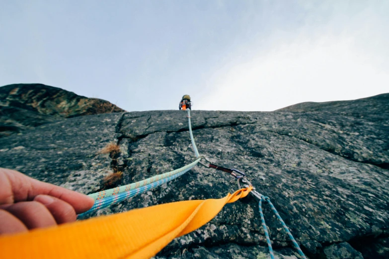 a man standing on top of a rock next to a rope, high quality product image”, helmet view, webbing, colour corrected