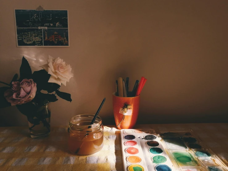 a jar of paint sitting on top of a table, a watercolor painting, trending on pexels, roses in cinematic light, sunrise coloring the room, lo fi colors, art station”