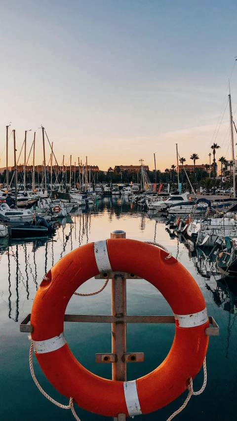 a marina filled with lots of boats and a life preserver, pexels contest winner, in barcelona, worksafe. instagram photo, kailee mandel, warm glow