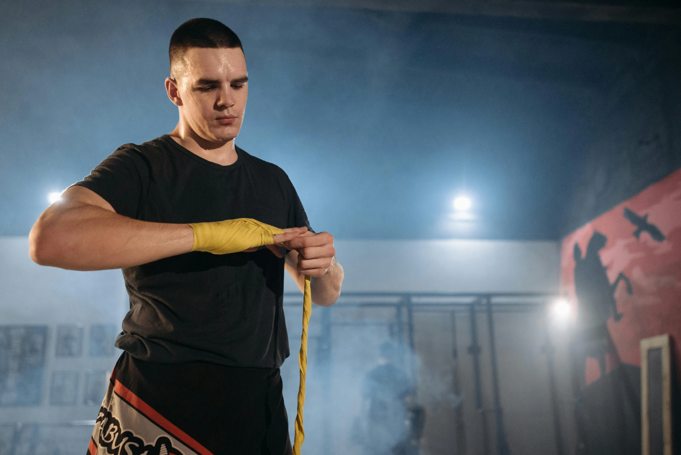 a man measuring his waist with a tape, a portrait, inspired by Carlos Berlanga, pexels contest winner, mma southpaw stance, with yellow cloths, profile image, with wires and bandages