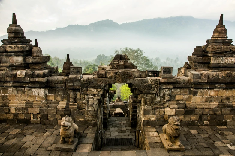 a group of statues sitting on top of a stone building, by Daniel Lieske, pexels contest winner, sumatraism, avatar image, an archway, “ aerial view of a mountain, background image