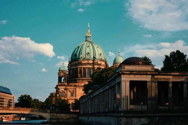 a large building sitting next to a body of water, pexels contest winner, berlin secession, cathedral, brown and cyan color scheme, profile image, dome