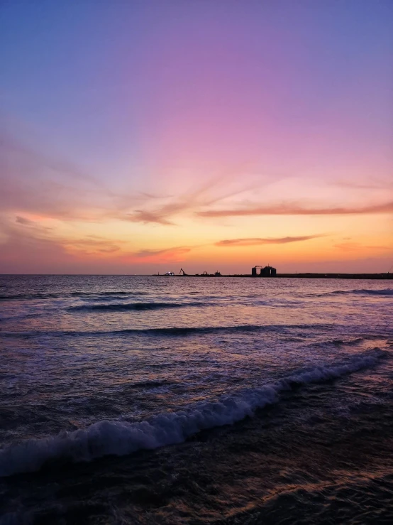 the sun is setting over the water at the beach, pexels contest winner, purple omnious sky, profile image, agrigento, low quality photo