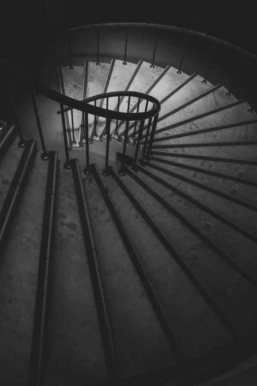 a black and white photo of a spiral staircase, inspired by André Kertész, unsplash contest winner, light and space, ) ominous vibes, alessio albi, staggered depth, photo taken in 2018