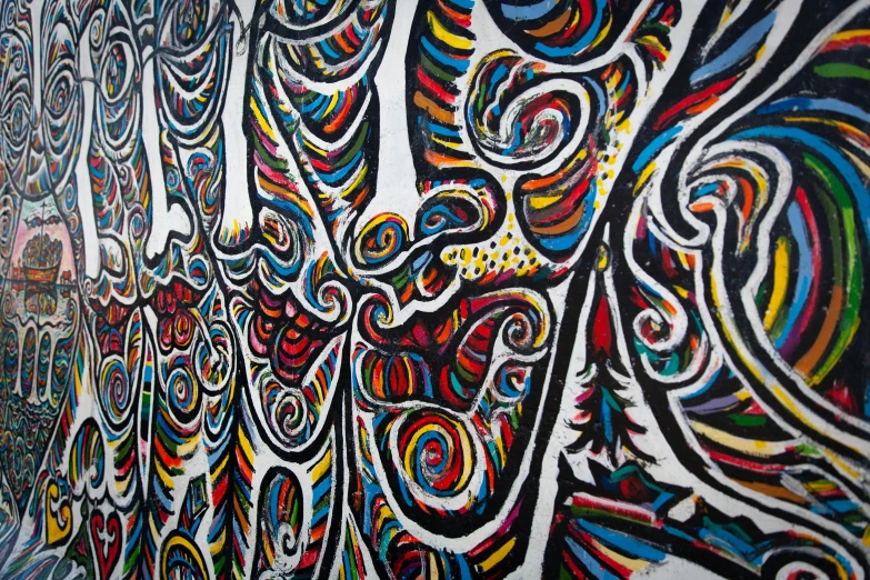 a colorful mural on the side of a building, a detailed painting, inspired by Jean Dubuffet, unsplash, psychedelic waves, closeup - view, painting on black canvas, tribal psychedelic