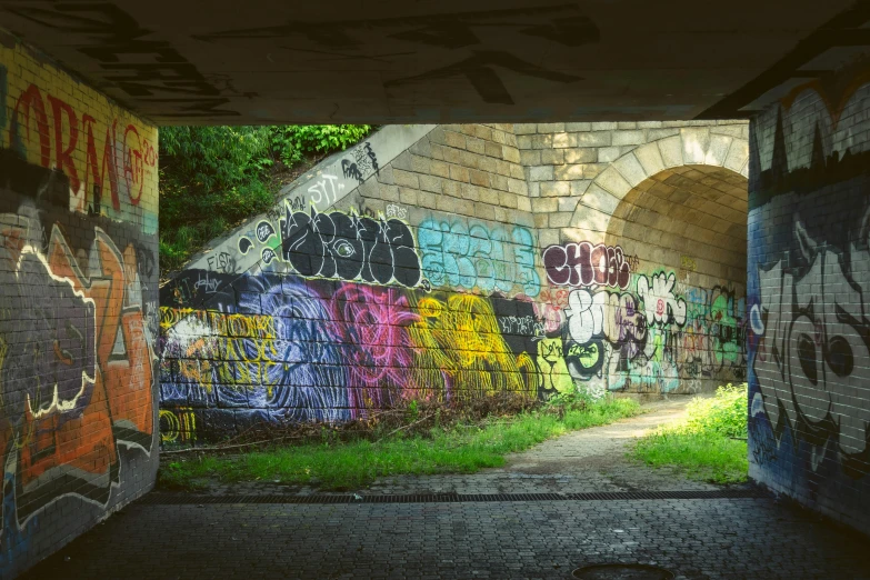 a tunnel that has graffiti all over it, by Daarken, unsplash, berlin park, instagram photo, evening light, taken in the late 2010s