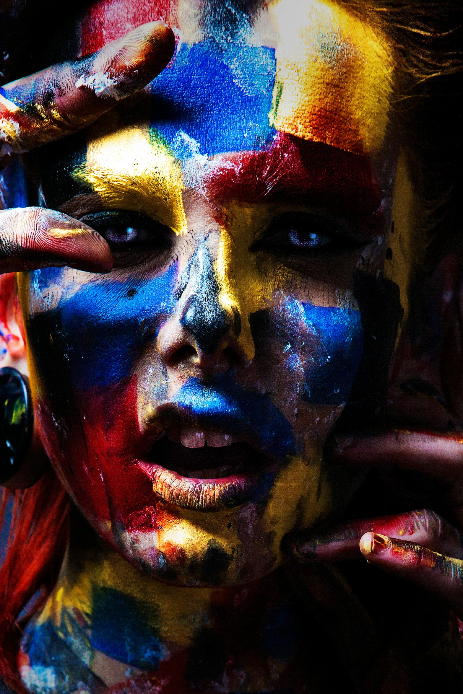 a close up of a person with paint on their face, an album cover, inspired by Steve McCurry, trending on pexels, art photography, an orgy of colorful, 5 0 0 px models, red yellow blue, full - body art