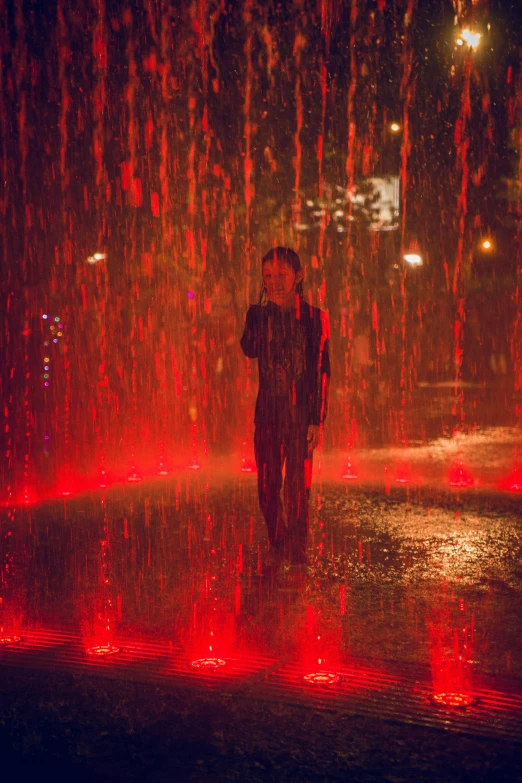 a person standing in a fountain with red lights, acid rain, wandering, orange and red lighting, it's raining