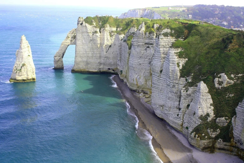 a large body of water next to a cliff, by Raphaël Collin, pexels contest winner, renaissance, the normandy landings, structural geology, youtube thumbnail, chalk cliffs above