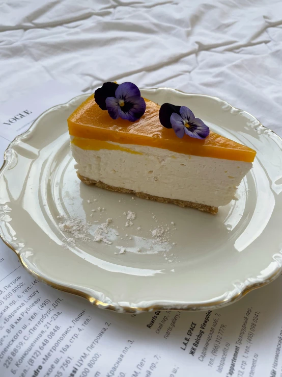 a piece of cheesecake sitting on top of a white plate, by Emma Andijewska, mango, 中 元 节, indoor, 🦩🪐🐞👩🏻🦳