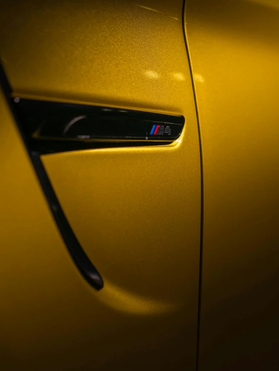 a close up of a car door handle, by Thomas Häfner, pexels contest winner, hyperrealism, yellow artificial lighting, “2019 bmw m5 wagon, profile posing, colors: yellow