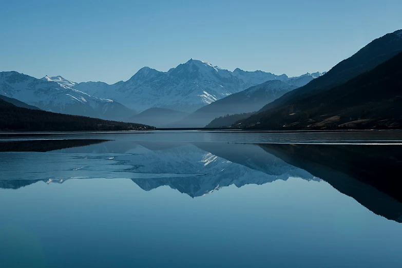 a body of water with mountains in the background, by Peter Churcher, pexels contest winner, hurufiyya, blue reflections, classic beauty, high quality photo, fine art print