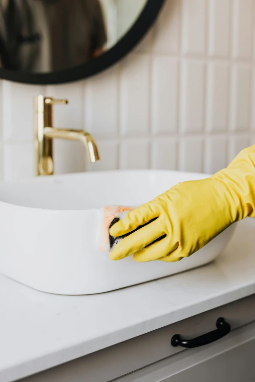 a person in yellow gloves cleaning a bathroom sink, by Nicolette Macnamara, collection product, elegant clean design, thumbnail, in house